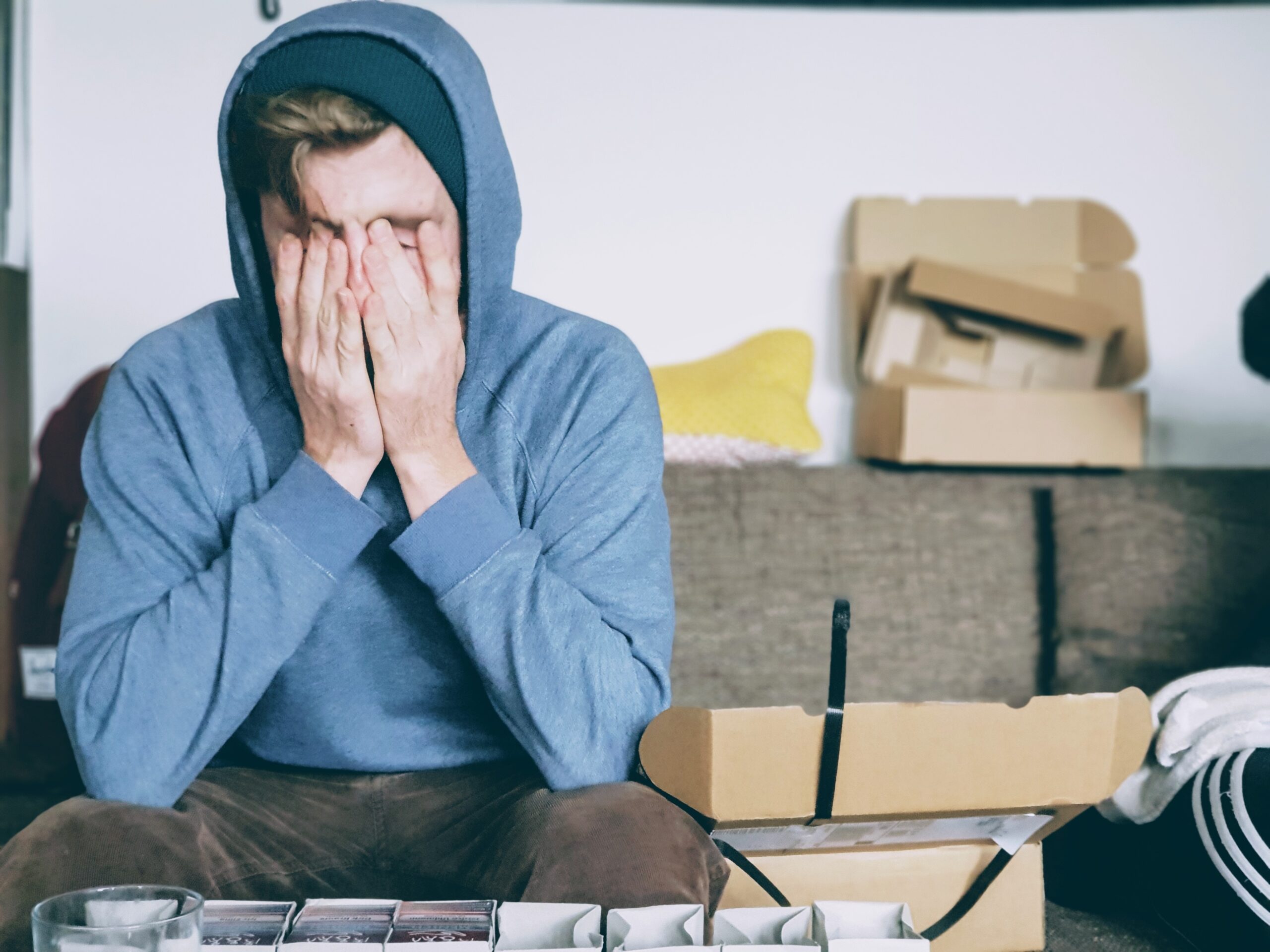 A man overwhelmed, head in his hands